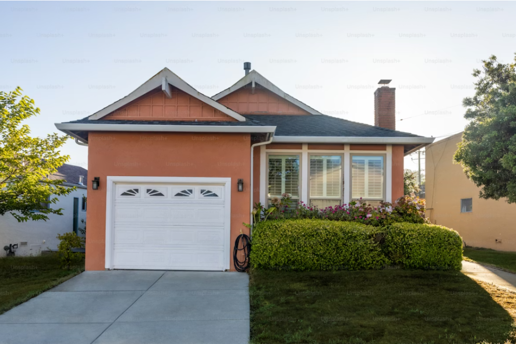 Front view of a modern home with a white steel garage door, illustrating how replacing garage door can improve home efficiency, durability, and curb appeal.