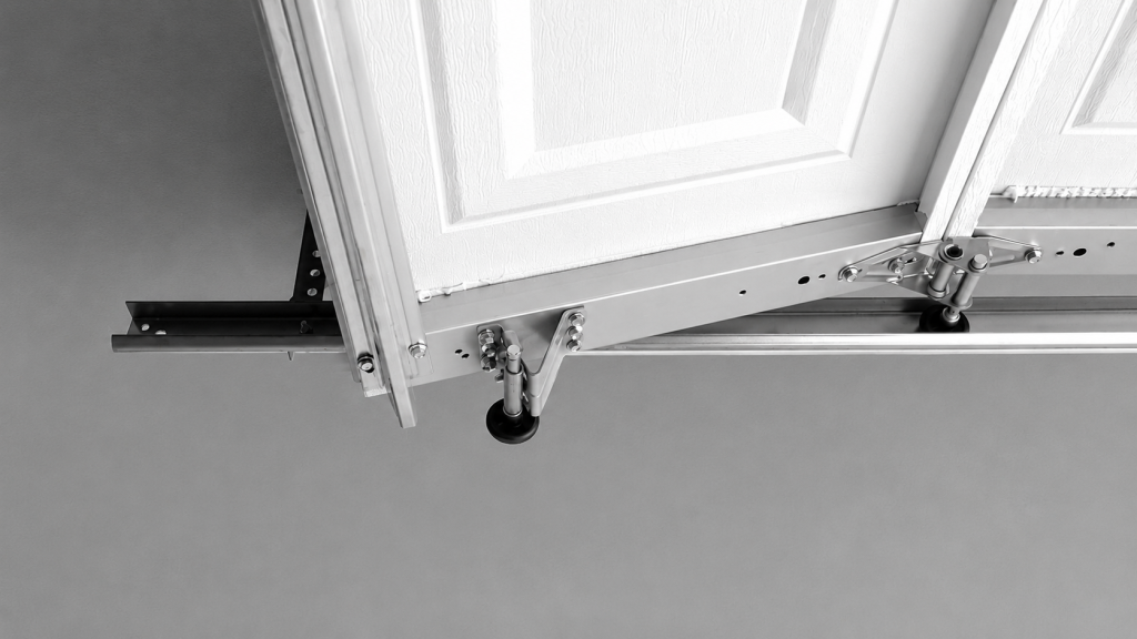 White garage door roller popping out of the track, showing a misaligned garage door system and damaged roller mechanism against a gray wall background.